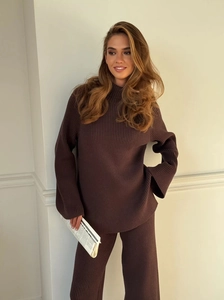 Detail of loose-fitting brown turtleneck knit sweater and wide-leg trousers set