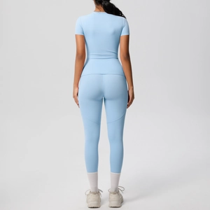 Rear view of tight-fitting light blue yoga set featuring high-waisted leggings and short sleeve top