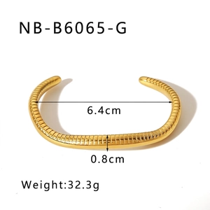 Detail view of gold geometric bracelet showing 6.4cm diameter and 0.8cm width specs