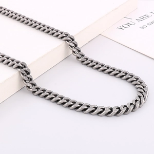 Close-up of vintage silver-tone stainless steel Cuban chain necklace with aged texture