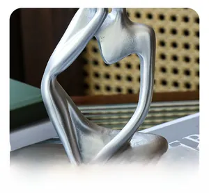 Detail of matte silver thinker sculpture showing seamless one-piece molding texture