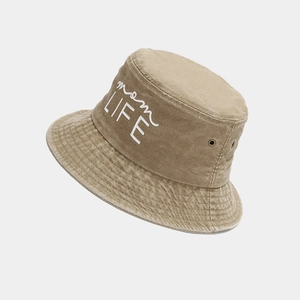 Detail of embroidered 'mom LIFE' text and metal eyelets on vintage washed cotton bucket hat