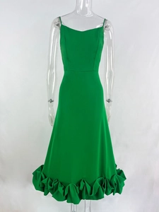 Detail of green slip dress showing slim fit design and ruffled hemline stitching