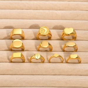 10-piece set of gold-plated stainless steel signet and geometric rings on beige display tray