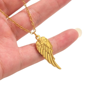 Gold angel wing necklace with rose texture on a delicate chain worn by a hand
