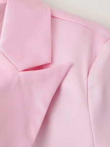 Close-up detail of smooth pink satin blazer lapel showing high-quality fabric texture