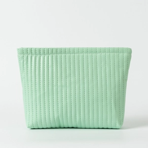 Detailed view of mint green quilted waterproof cosmetic bag with vertical stitching texture