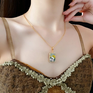 Detail of vintage flower pendant necklace with zircon and enamel on a female model