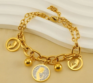 Close-up of gold stainless steel multi-layer bracelet with Virgin Mary and silhouette charms