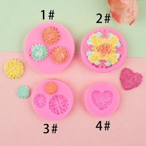Detail of four pink silicone floral molds with embossed heart and flower textures