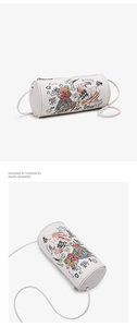 Detail of white cylinder crossbody bag with colorful graffiti bear and star prints