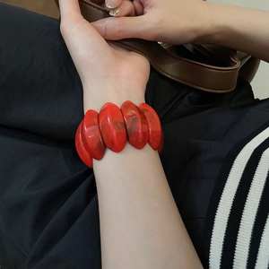 Macro shot of red marble resin bracelet texture and vibrant acrylic geometric links