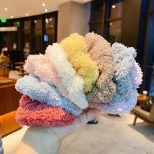 Close-up of soft plush velvet hair ties in various colors like pink, blue and yellow