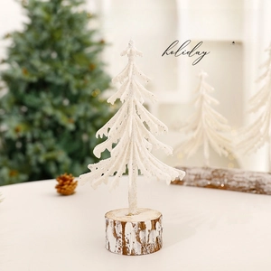 Mini white frosted cedar Christmas tree with natural wood base for holiday desk decoration