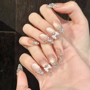Pink cat eye press-on nails with 3D white bows and silver glitter in almond shape