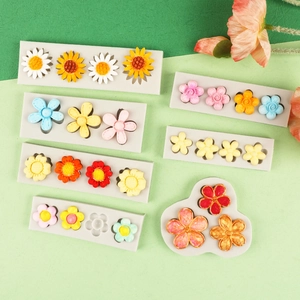 Detailed view of various flower-shaped silicone molds for fondant and cake decoration