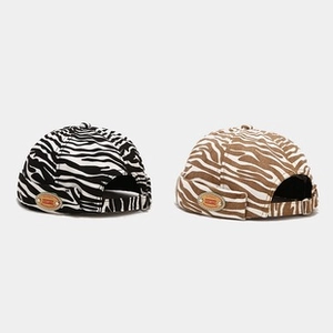 Detail view of zebra print brimless dockers caps with adjustable back buckles
