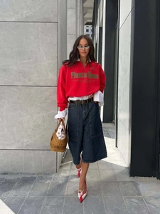 Stylish red half-zip sweatshirt with letter print paired with dark wide-leg jeans