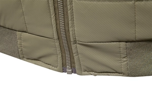 Detailed macro view of olive green jacket with quilted texture and elastic ribbed hem