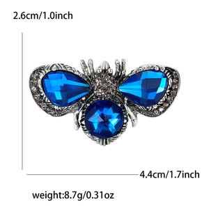 Bee-shaped brooch with blue crystals and grey rhinestones on a silver alloy base
