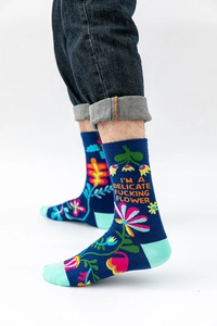 Detailed knit texture of navy blue cotton socks with colorful floral pattern and slogan