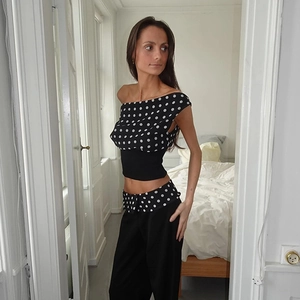 Detailed close-up showing the trendy polka dot patterns and unique asymmetric shoulder design
