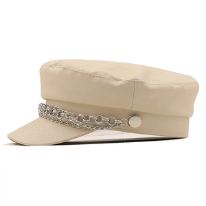 Detail of off-white PU leather baker boy hat with triple silver chain and metal studs
