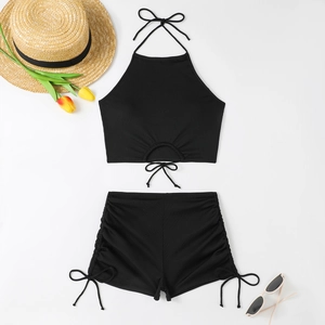 Close-up of black ribbed bikini set with lace-up halter neck and side drawstring details