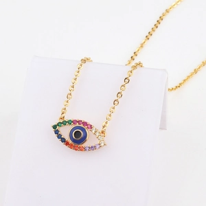 Detail of 18k gold necklace with rainbow zircon evil eye heart pendant on white stand