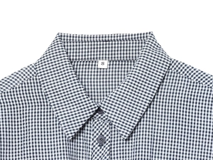 Close-up of the small black and white plaid shirt collar with a size S clothing label