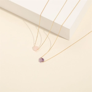 Minimalist heart-shaped amethyst and rose quartz pendant necklace on gold fine chain