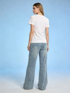 Rear view of women's loose high waist light blue wide leg jeans with white t-shirt
