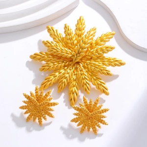 Golden wheat ear jewelry set with brooch and matching stud earrings on white background