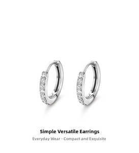 Macro shot of S999 sterling silver huggie earrings with shimmering cubic zirconia stones