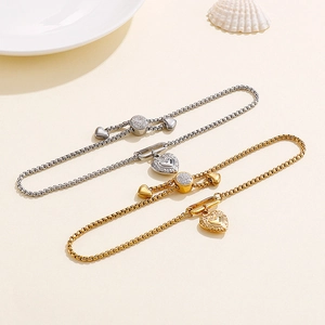 Minimalist stainless steel heart charm pull bracelet in gold and silver finishes