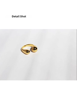 Detail shot of 18K gold plated brass open ring with polished droplet ends