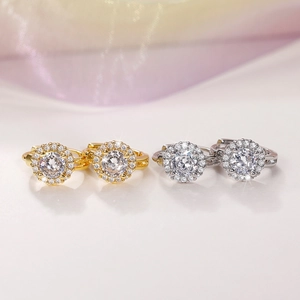 Macro view of gold and silver halo earrings featuring cubic zirconia in a hoop design