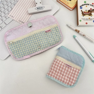 Detailed view of quilted cotton pouches with heart stitching and secure zipper closure