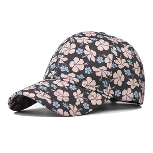 Detail of floral baseball cap with hibiscus print and reinforced stitching on visor
