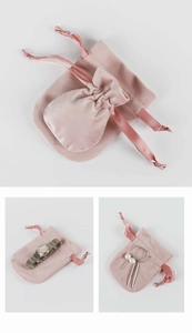 Detailed view of pink velvet drawstring pouches in two sizes with jewelry inside