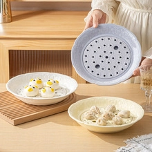 Ceramic egg holders in purple, white and yellow shown with food on a wooden table