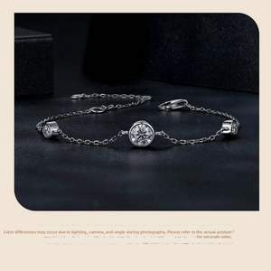Detail of 925 sterling silver chain bracelet with three round bezel-set moissanite stones