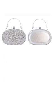 Detail of silver evening clutch bags with sparkling rhinestones and metal ring handles