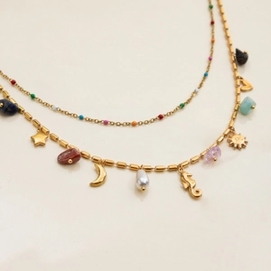 Detail of 18K gold stainless steel necklace with seahorse, moon and colorful stone charms