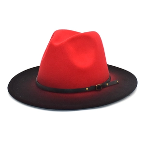 Detail of red and black gradient fedora hat with a leather belt and metal buckle