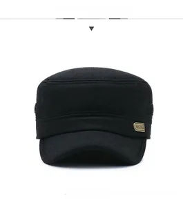 Detail view of the black wool cadet cap featuring a side rectangular gold metal logo plaque