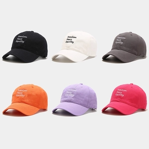 Multiple colors of cotton baseball caps featuring Freedom Peace Equality embroidery