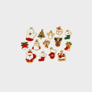 Detailed macro view of colorful enamel Christmas charms featuring snowman and reindeer designs