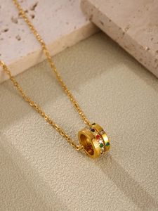 Macro view of gold ferris wheel pendant with multi-color stones and With Love engraving