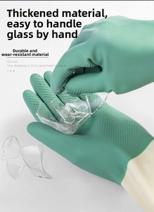 Close-up of green rubber gloves with non-slip texture handling broken glass shards